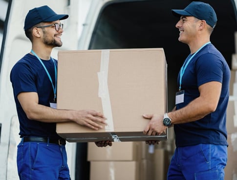 Warehouse team handling a parcel during loading