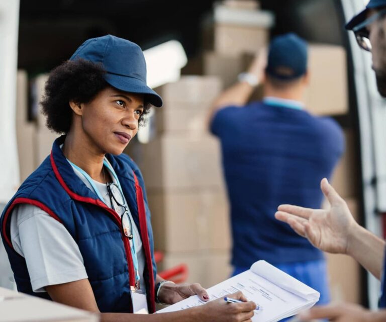 Logistics coordinator checking shipping documents at a loading bay