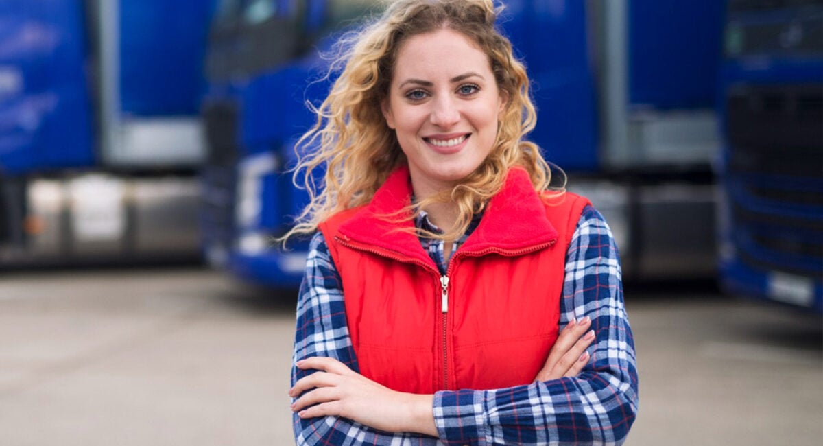 Fleet supervisor in front of a line of heavy trucks