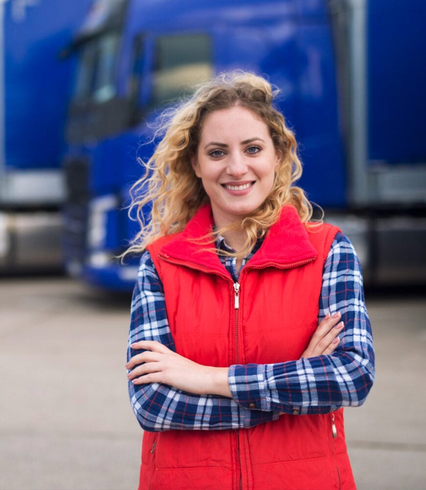 Fleet supervisor in front of a line of heavy trucks