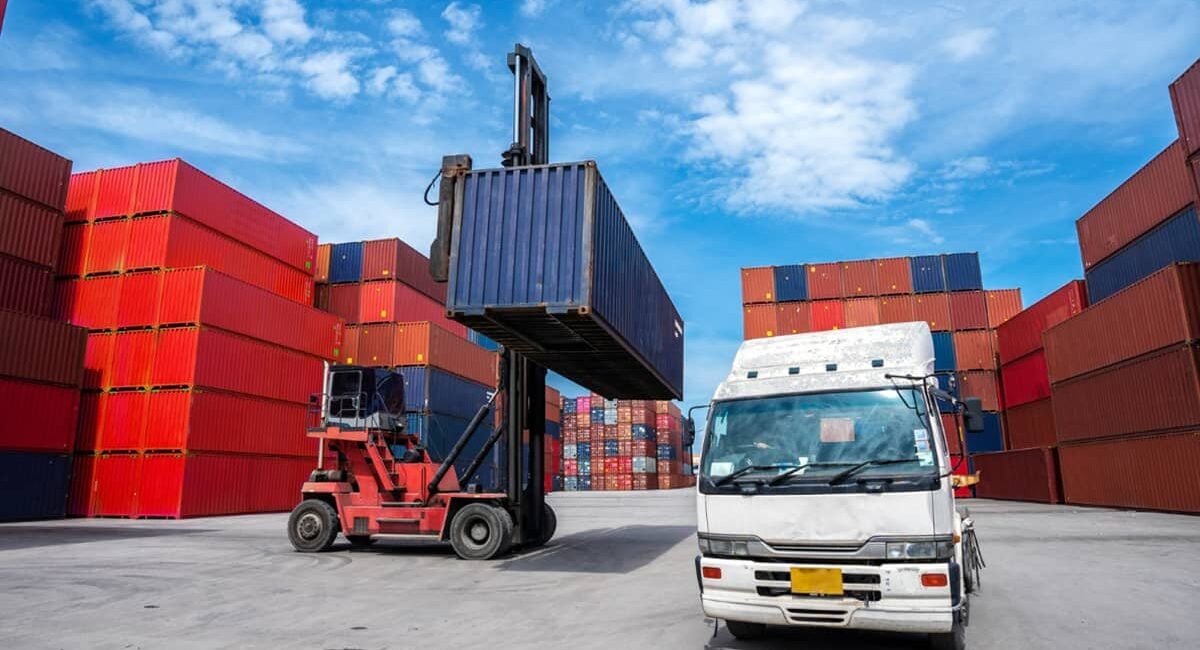 Containers being handled in a port terminal yard