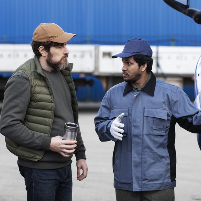 Operations supervisor briefing a driver at a loading yard